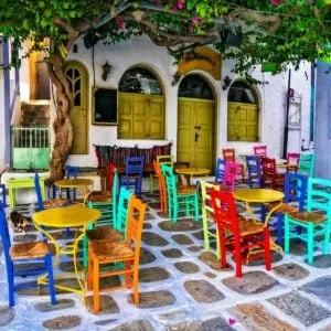 Alfresco Diner With Colorful Seats In Ios, Greece