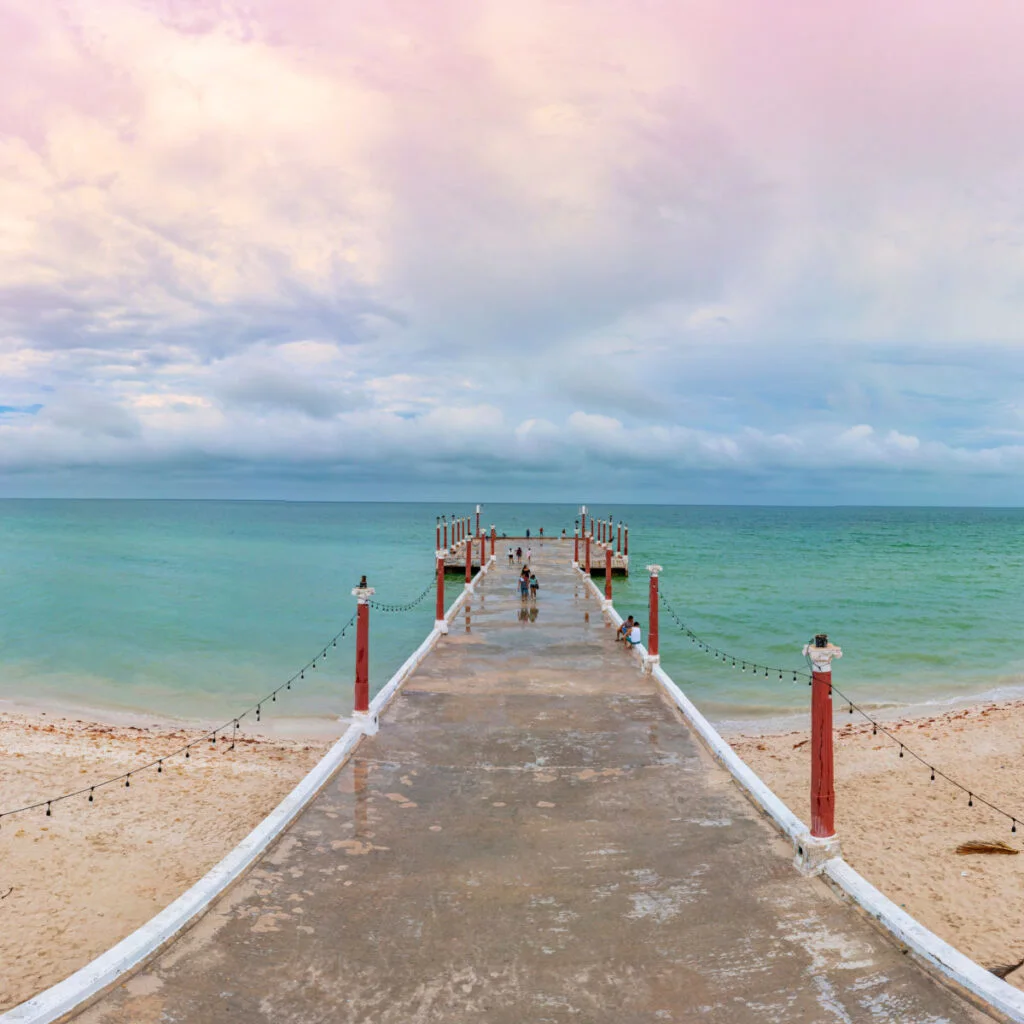 Pier in Sisal, Mexico over emerald waters