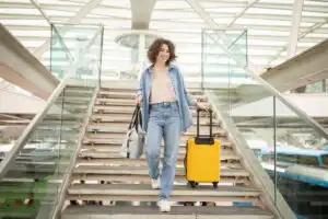 Happy traveler with luggage at airport