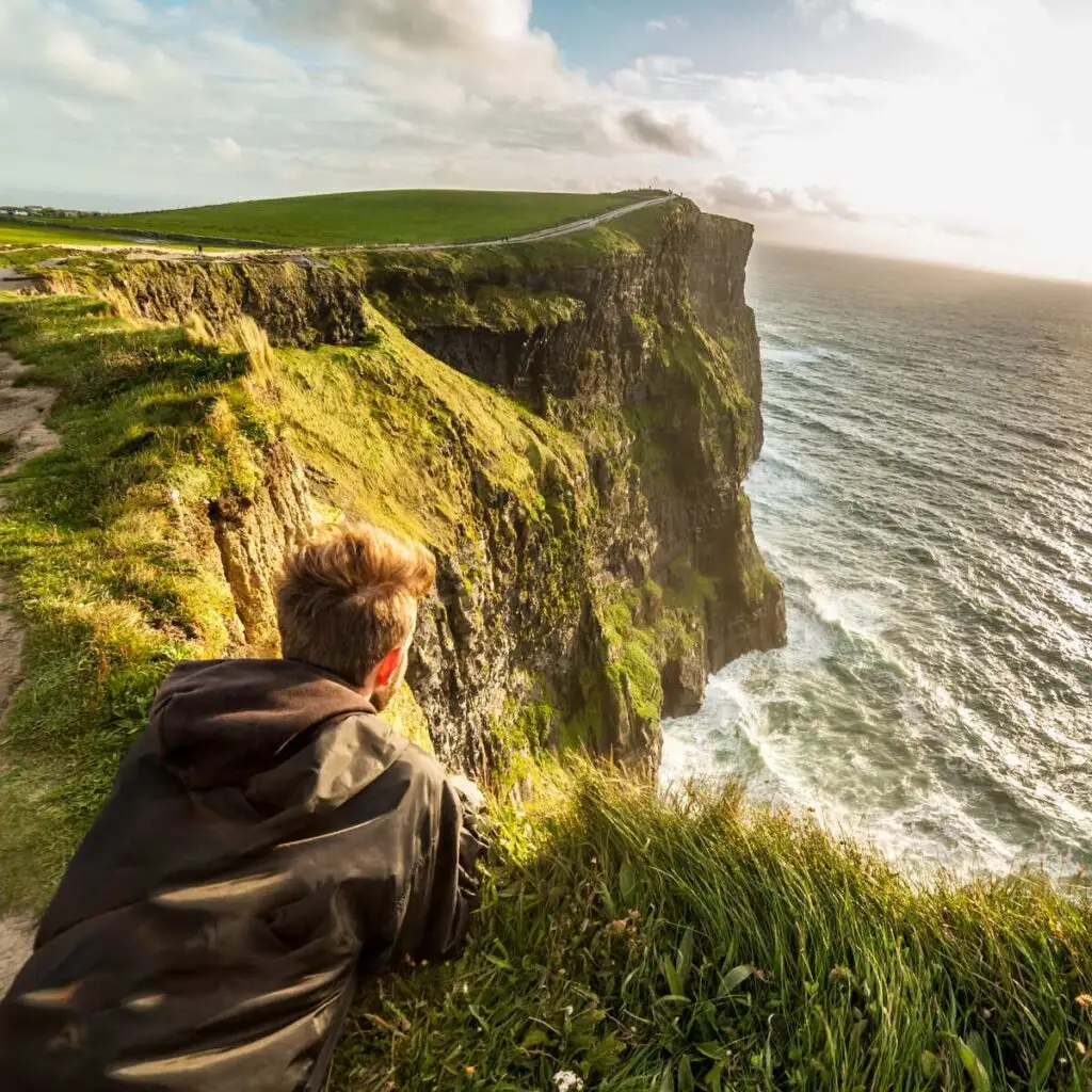 Young Man Admiring A View Of The Cliffs Of Moher, Ireland