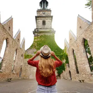 Woman visiting historic church in Hanover, Germany