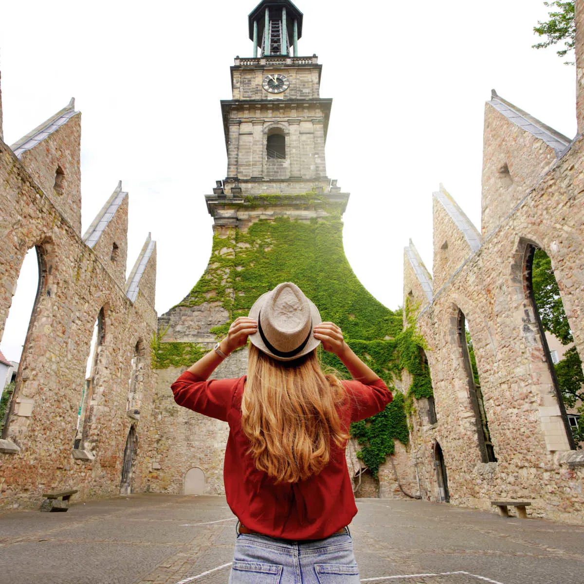 Woman visiting historic church in Hanover, Germany