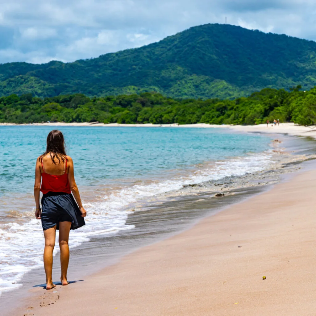 Young woman taking walk on beach in Costa Rica