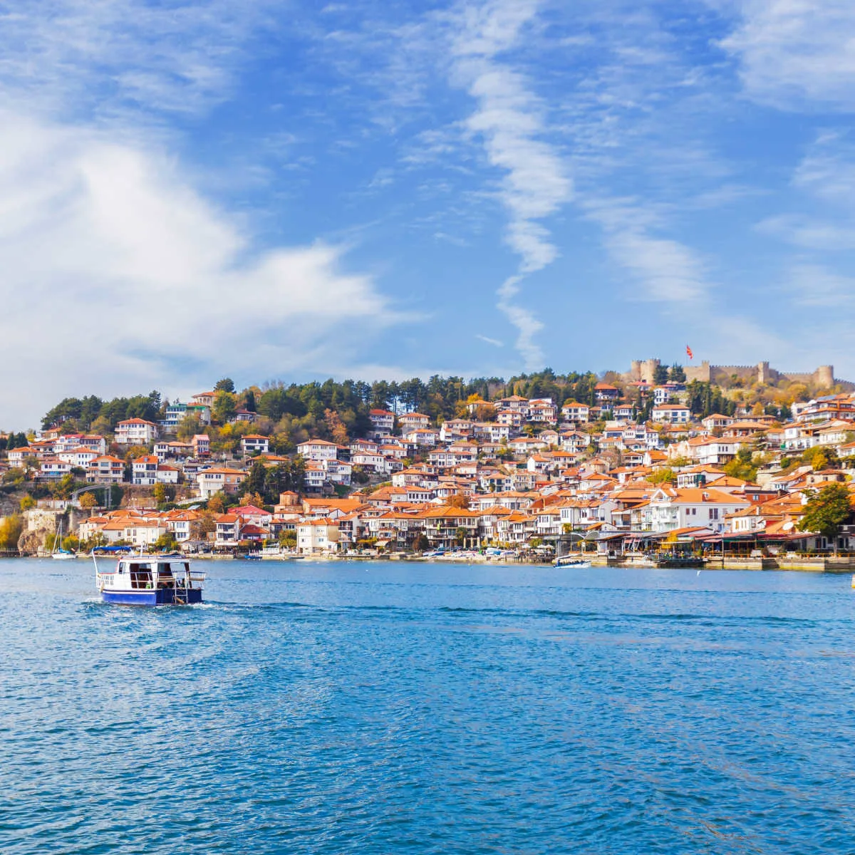 Boats riding by townscape of Lake Ohrid, North Macedonia