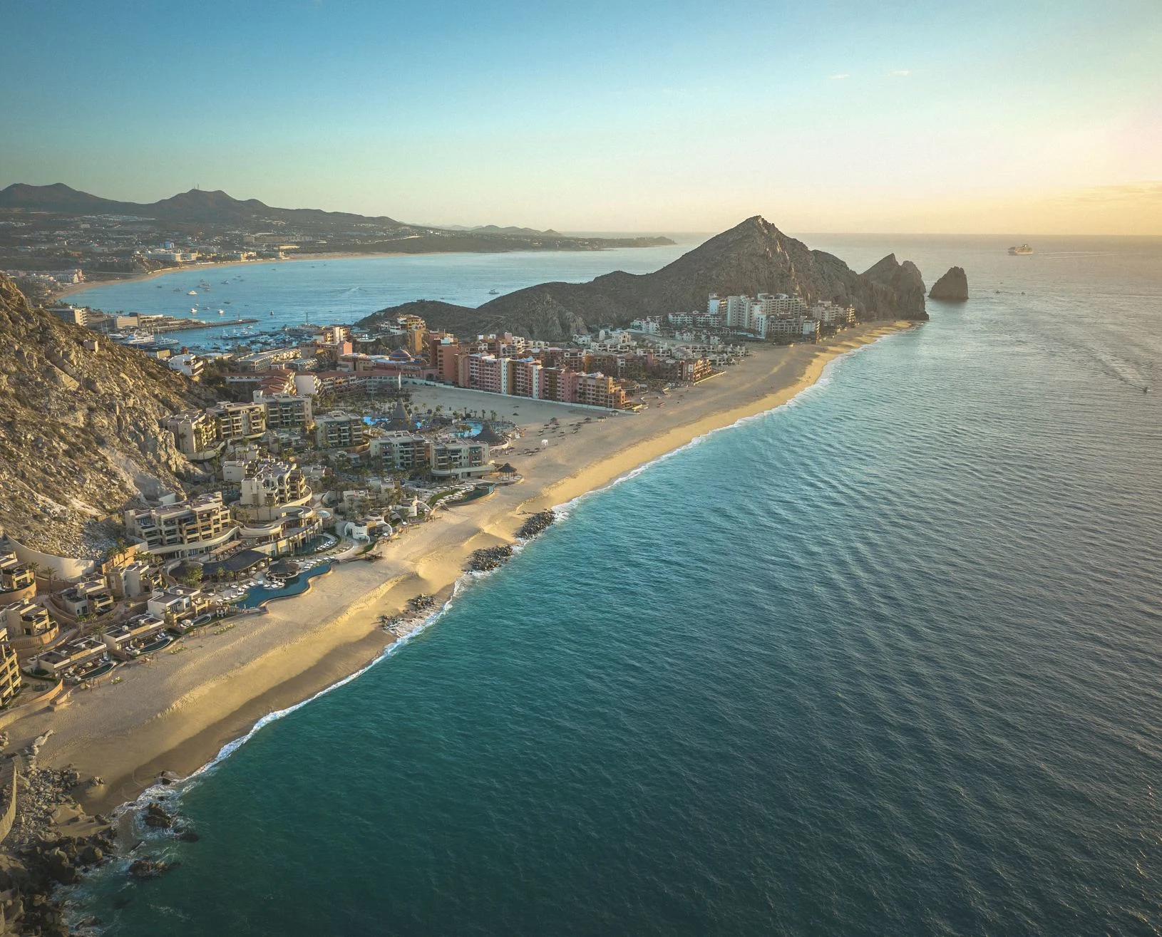 2 US Cities Launching First Ever Flights To Popular Beach Destinations Cabo resorts at sunset