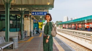 Backpacker waiting at train station