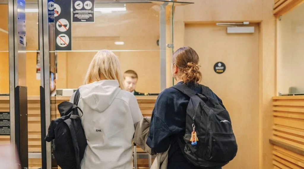 Women at airport being interviewed by immigration