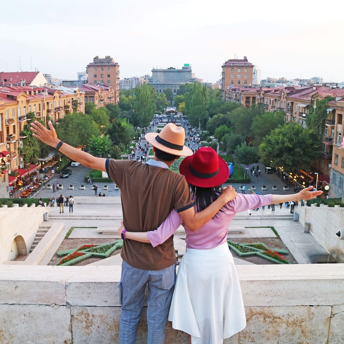 A Couple Of Tourists Admiring A View Of Yerevan From Atop The Cascade Complex, Armenia