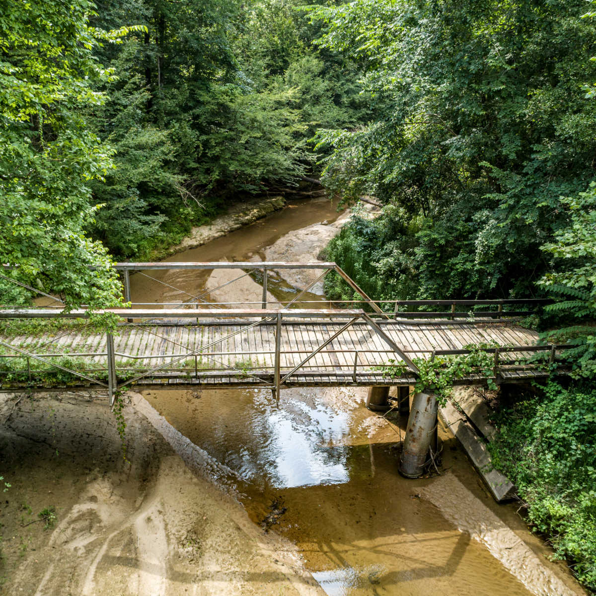 This Affordable Riverside Town Oozes Southern Charm & European Vibes Bridge over river in Port Gibson, MS