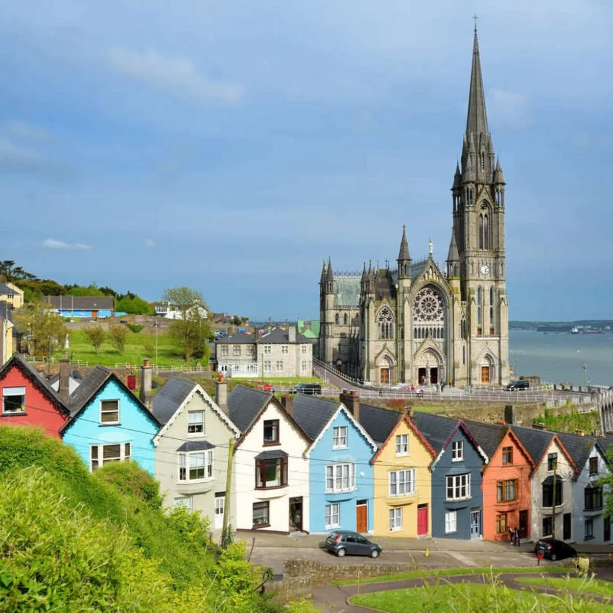 Colorful Row Of Houses With A Cathedral In The Background In Cobh Near Cork, Ireland
