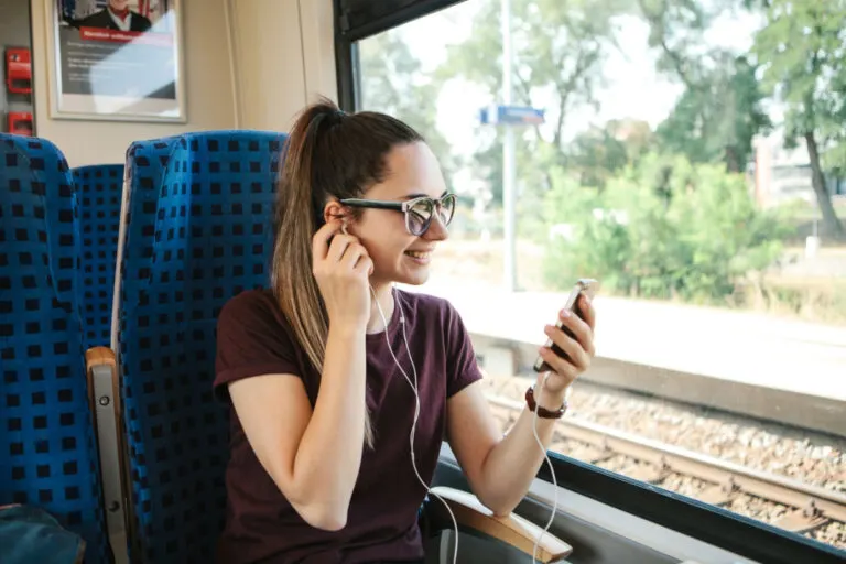 Woman on train listening to music