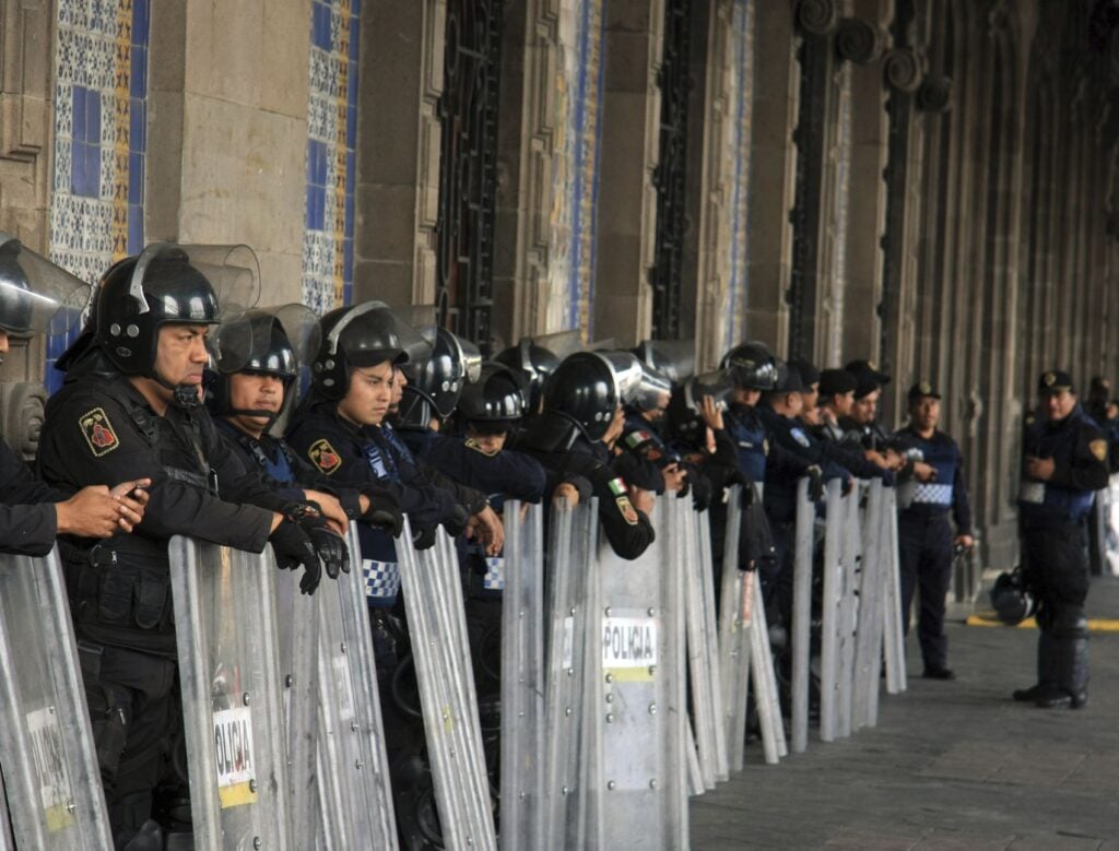 Mexican Police Officers in Riot Gear outside building in Zocalo Square, Mexico City