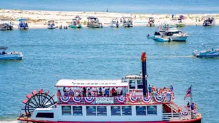 The Betsy Ann riverboat passing white sand beach in Biloxi