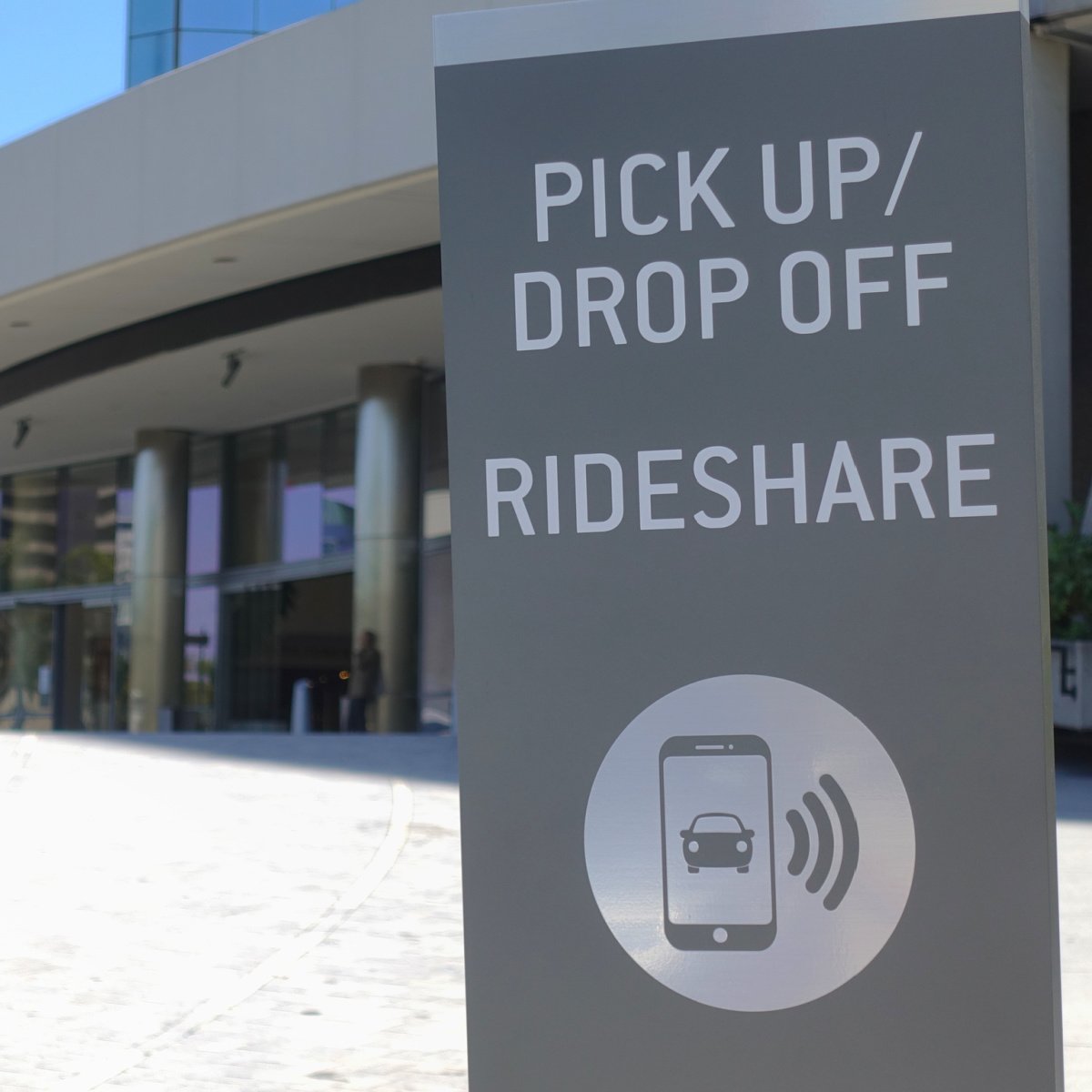 Rideshare zone sign at hotel curb