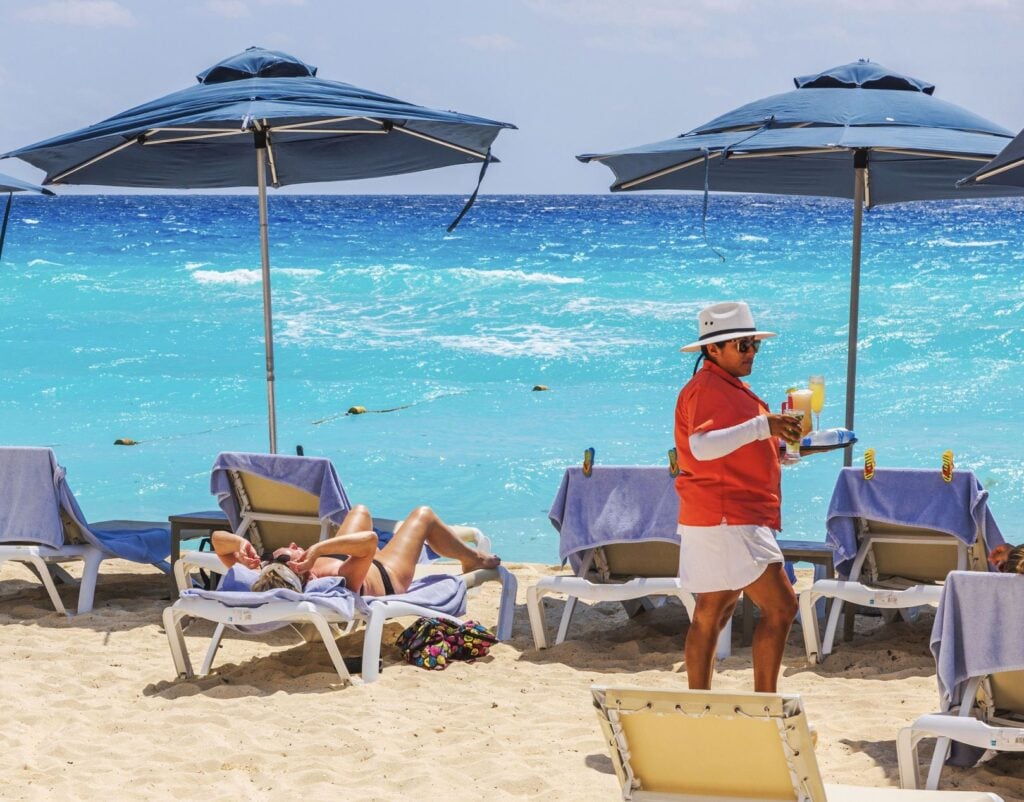 Server Brings drinks at all-inclusive resort in Mexico to Tourists