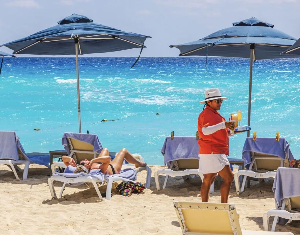 Server Brings drinks at all-inclusive resort in Mexico to Tourists