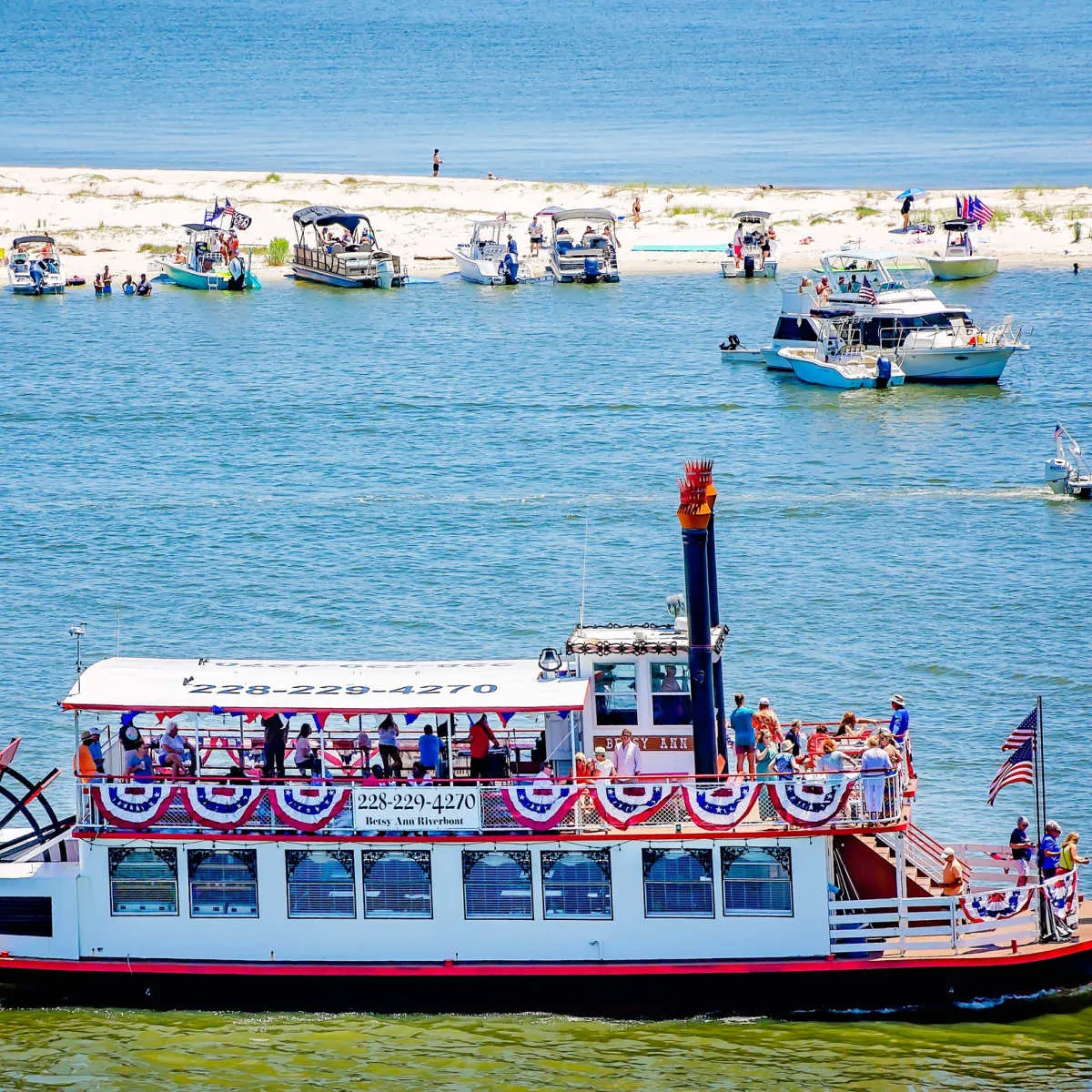 The Betsy Ann riverboat passing white sand beach in Biloxi