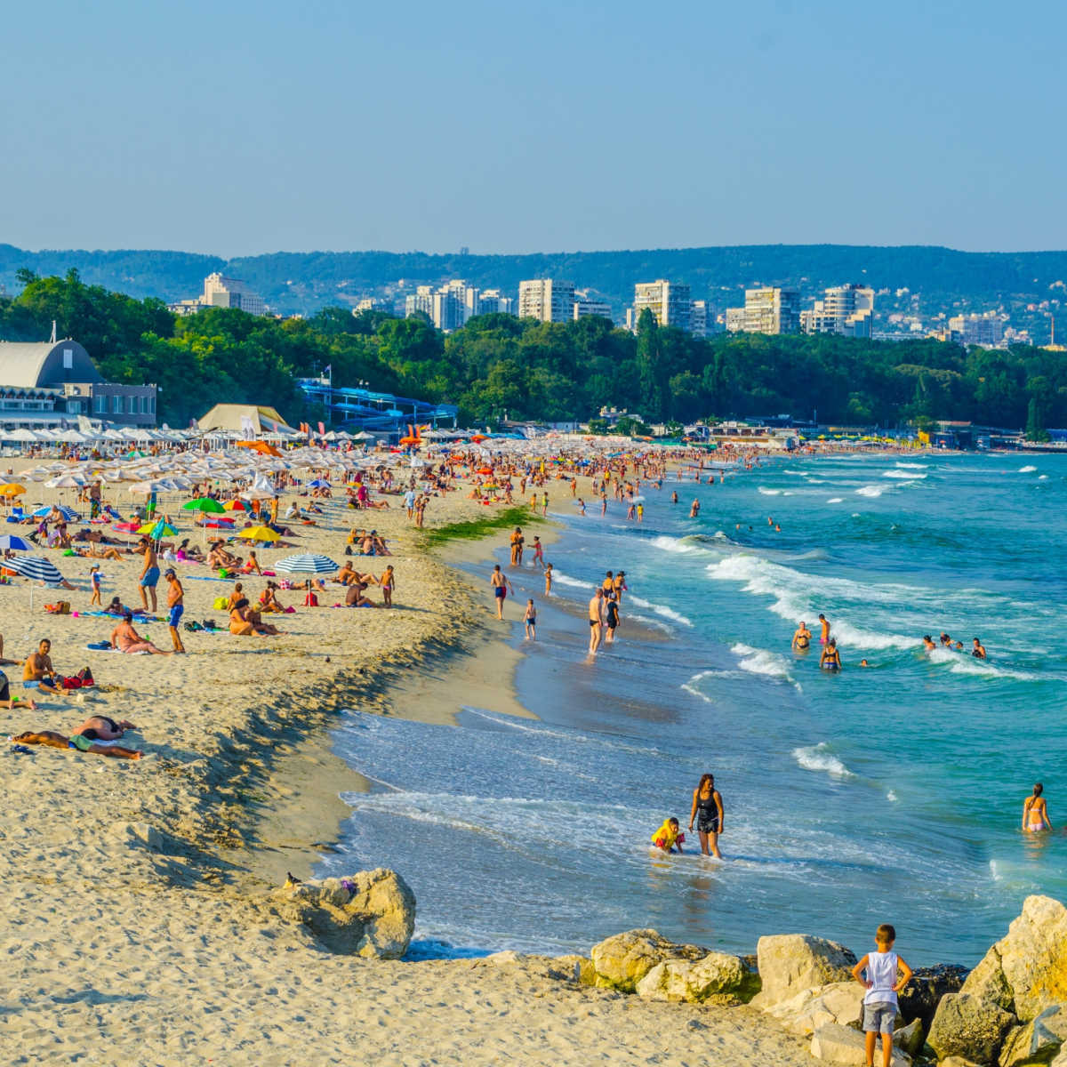 5 Surprising European Cities Surging In Popularity This Summer Vacationers enjoying summer on a beach in Varna, Bulgaria