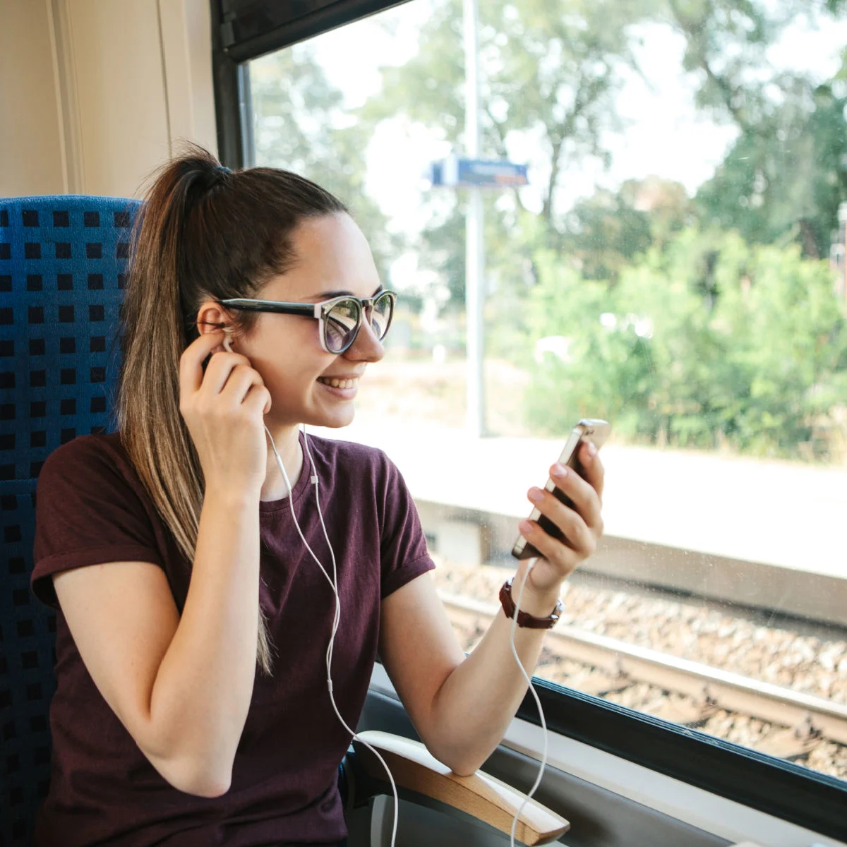 Woman on train listening to music