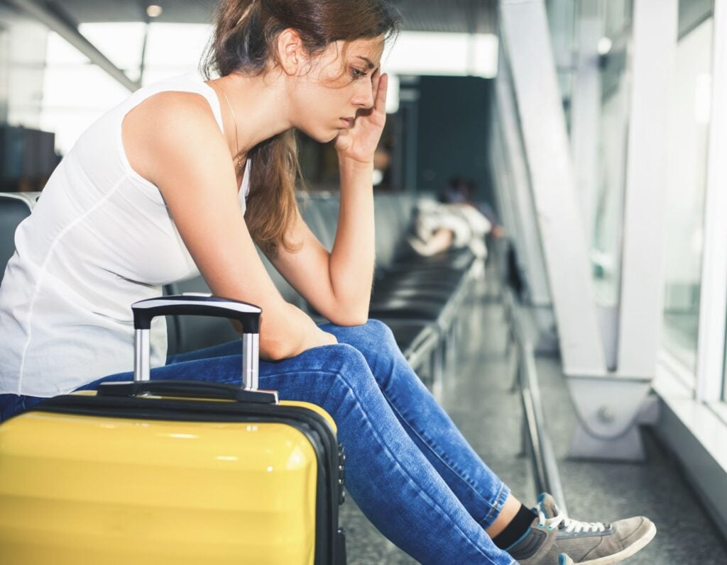 Woman waiting for delayed flight frustrated
