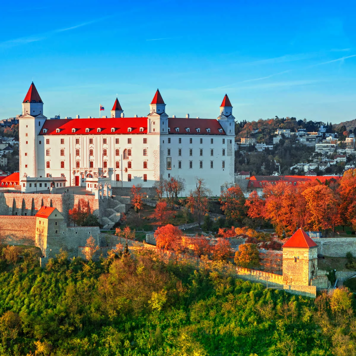 Bratislava Castle surrounded by crimson trees