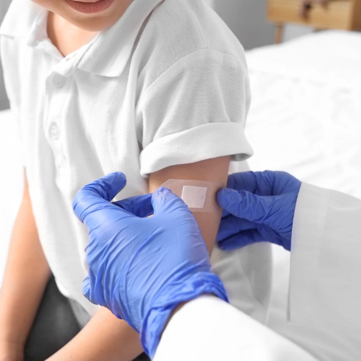Child with bandage after vaccination