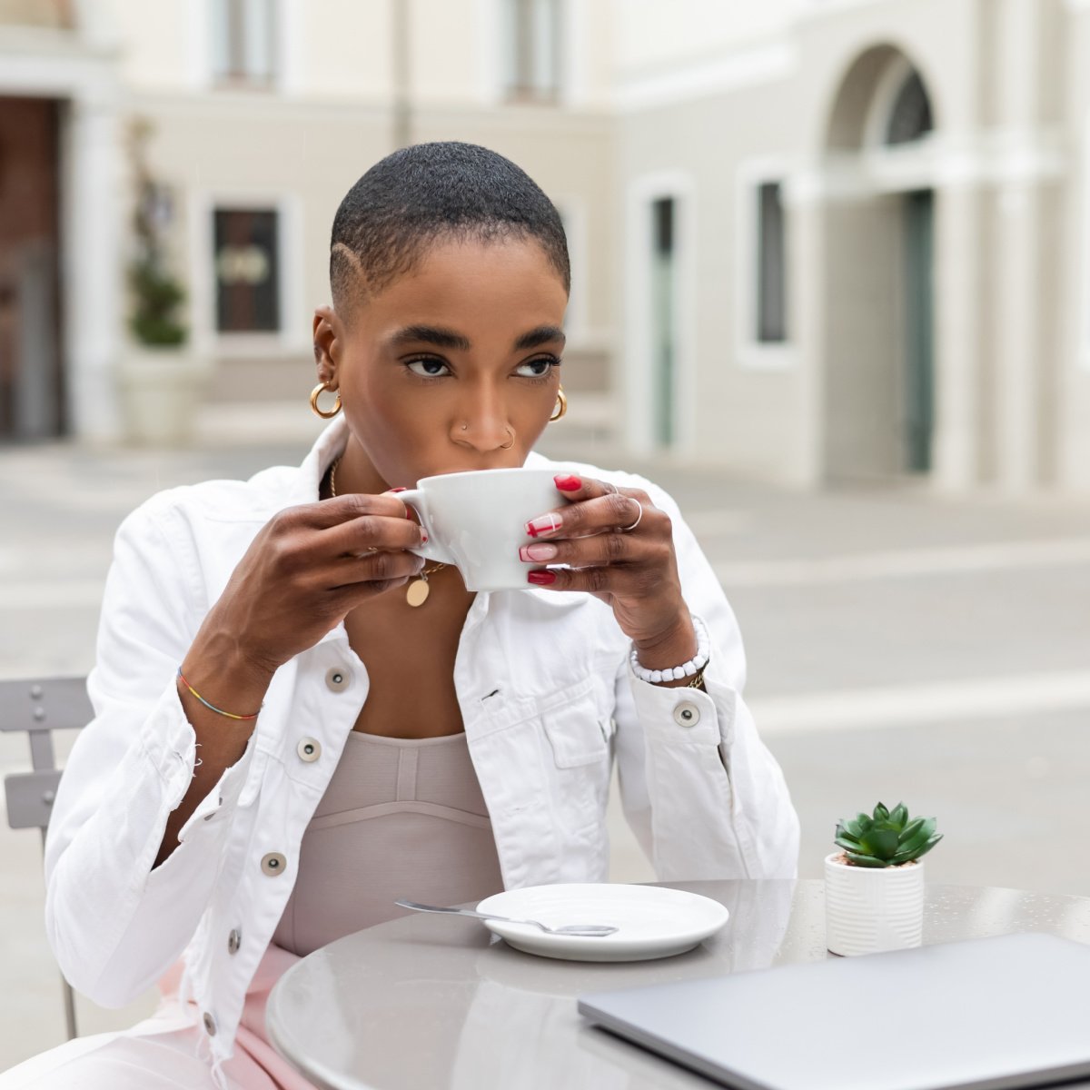 Digital nomad sipping coffee at European cafe