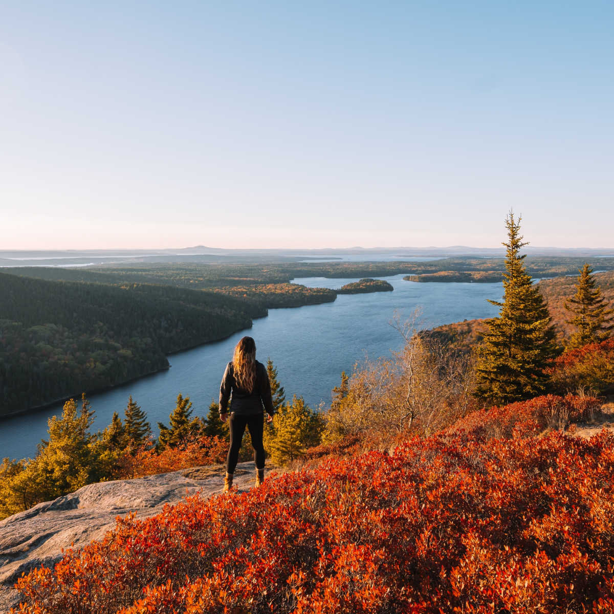 Hiker taking in view of Acadia National Park in fall