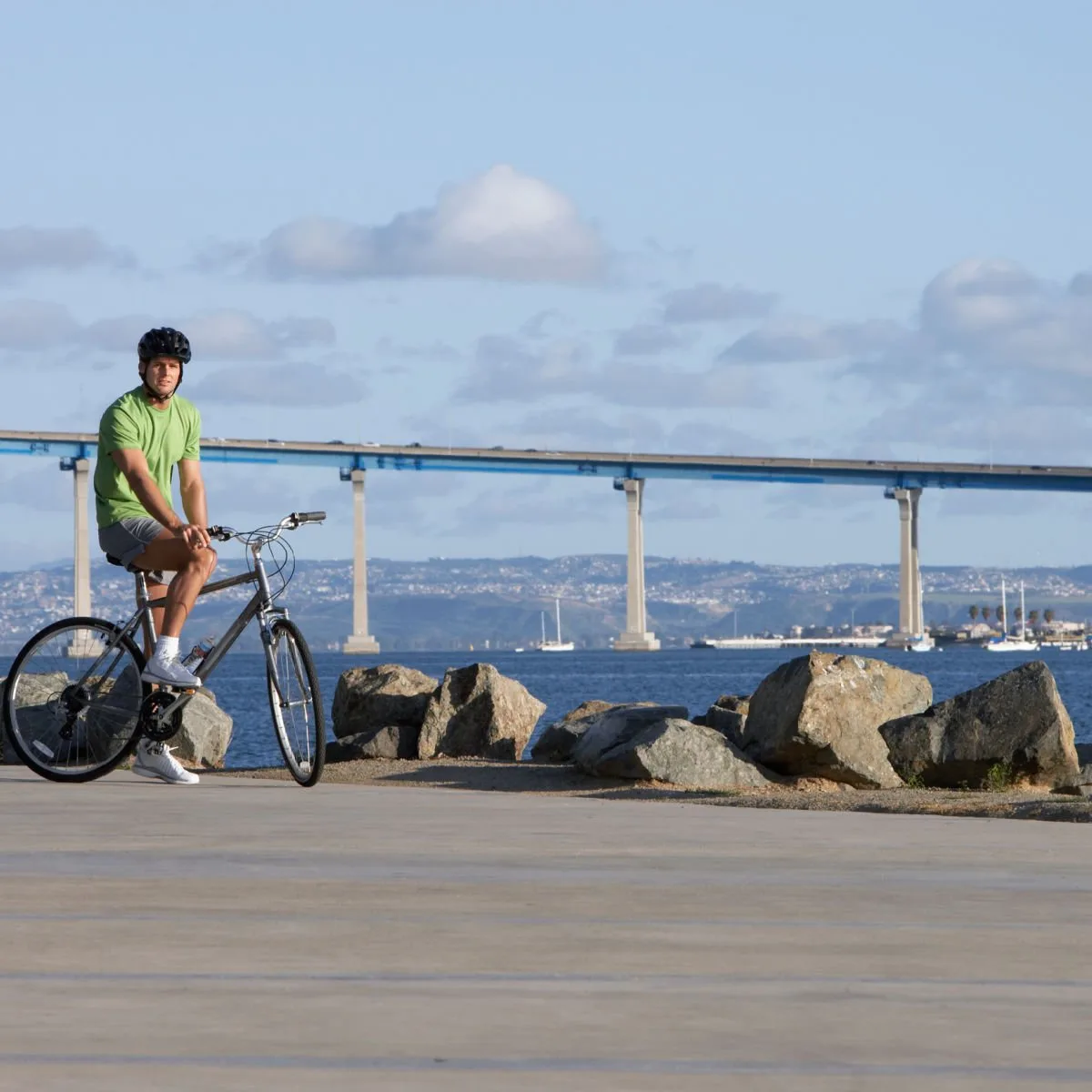 San Diego's White-Sand Paradise: Discover New Hotels & Vintage Charm This Summer Man riding bike in Coronado, CA