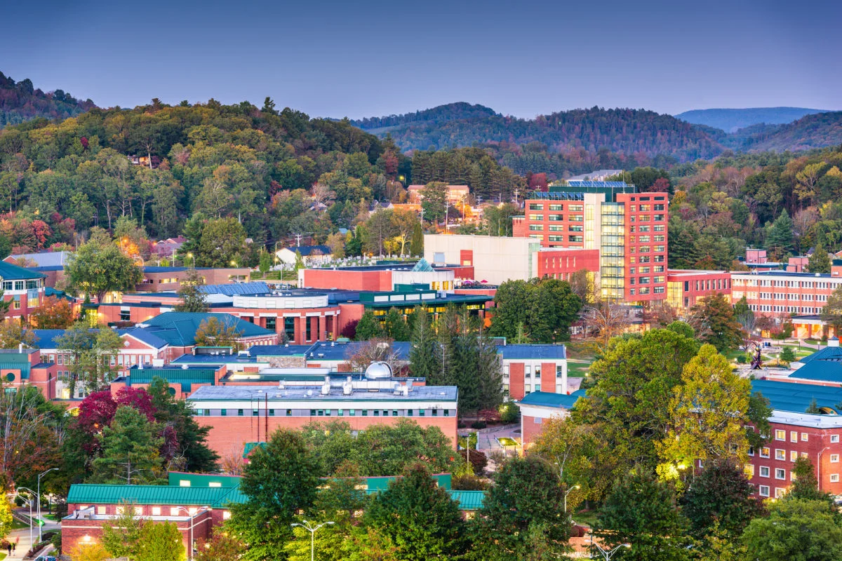 North Carolina's Next Hotspot Unveiled: Enjoy Less Crowds In This Rustic Mountain Town Boone, NC townscape surrounded by lush vegetation