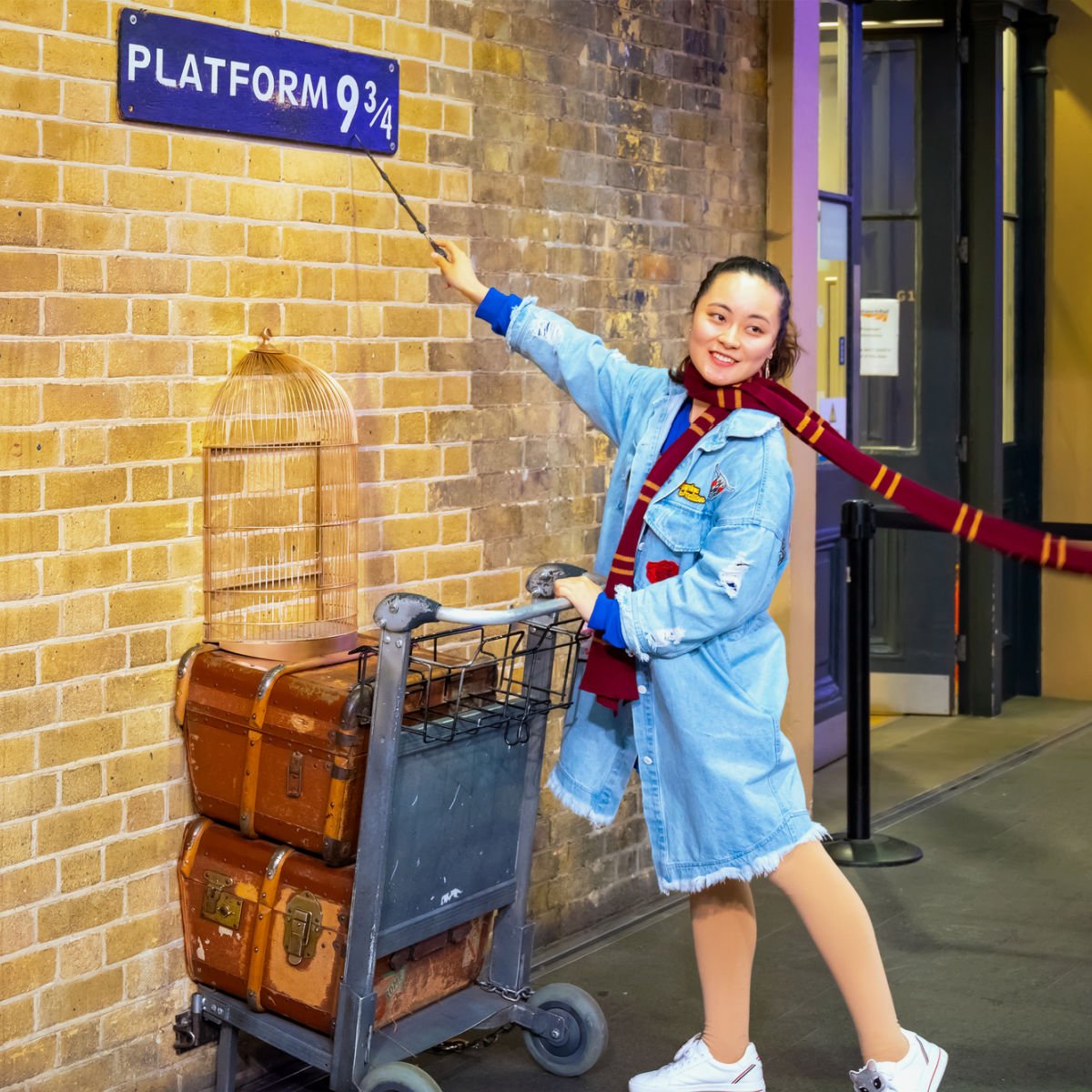 Traveler in Harry Potter attire at King's Cross in London