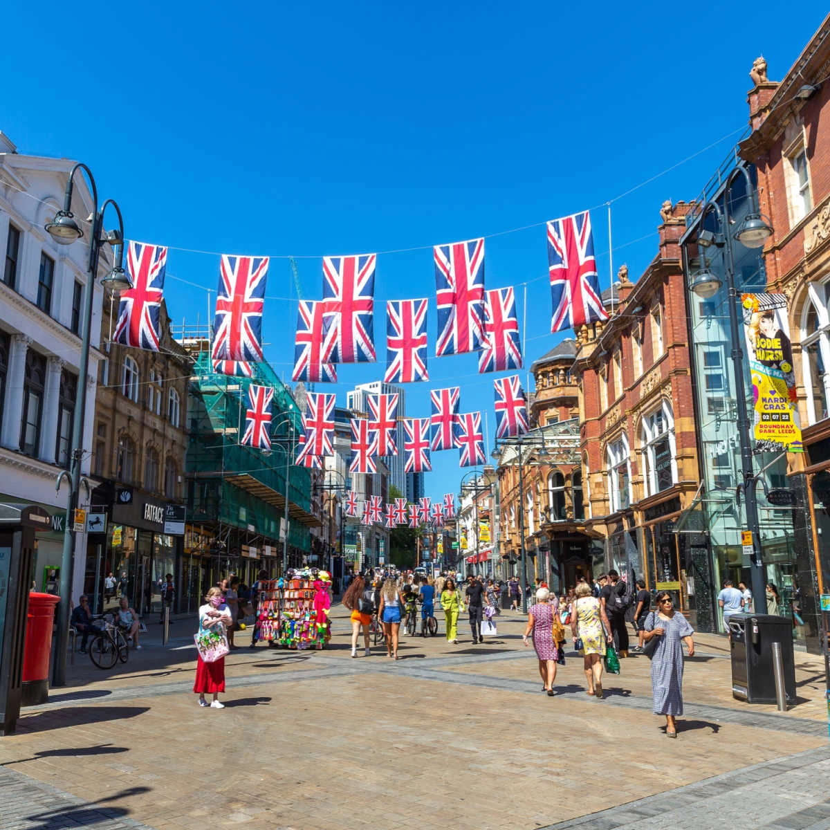 UK flags hanging over busy promenade in Leeds