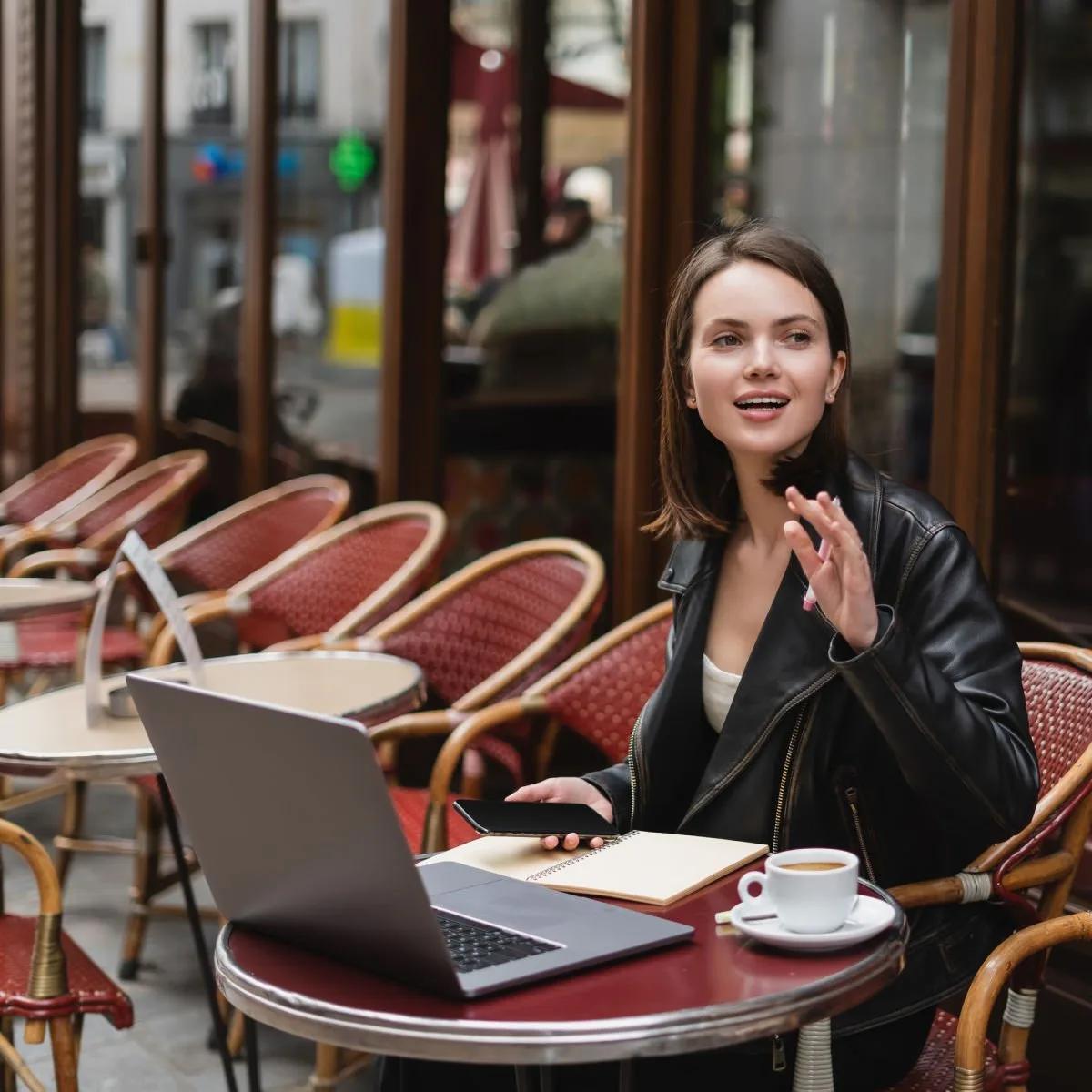 Digital nomad sitting at European sidewalk cafe