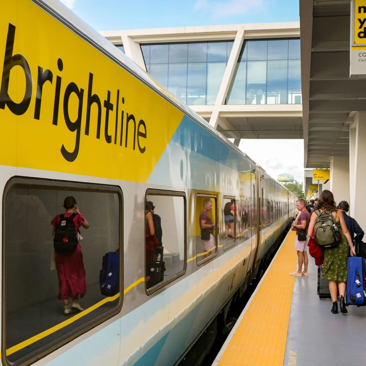 Travelers walking away from Brightline train