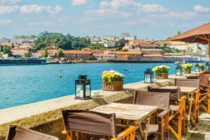 View of open-air street cafe on the banks of the River Douro in Porto, Portugal
