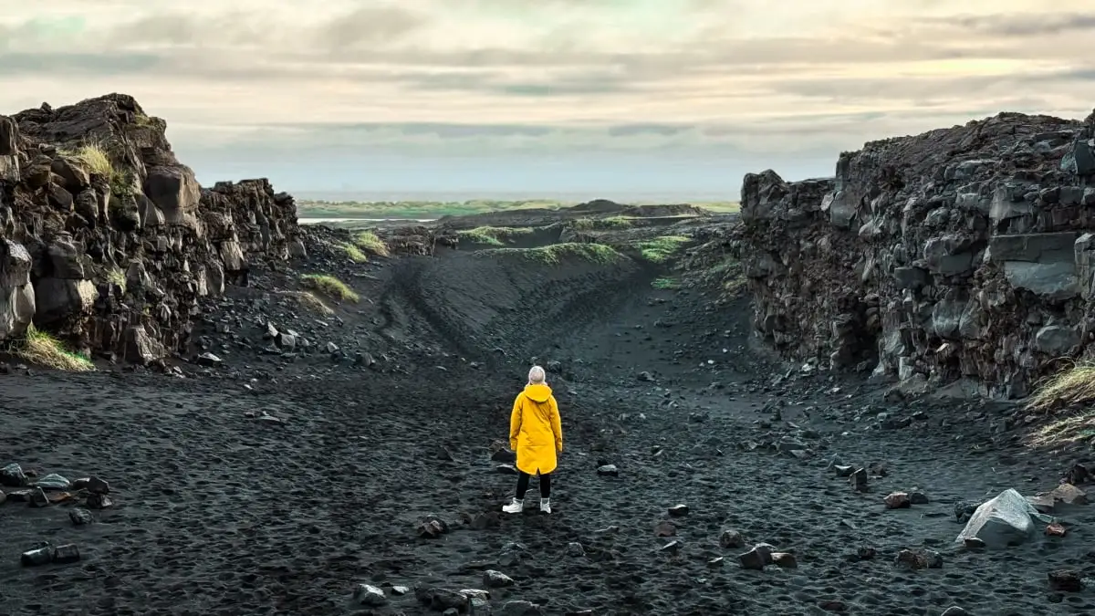 Woman in Iceland between tectonic plates