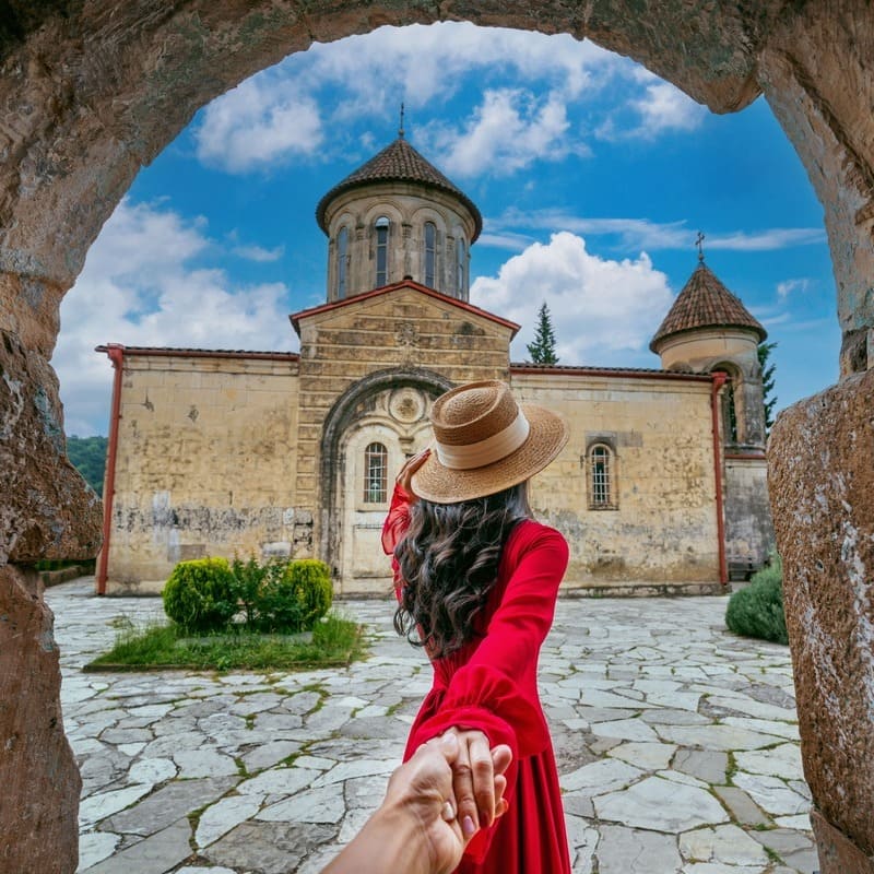 Young Woman Exploring A Medieval Monastery In Georgia, Caucasus Region Of Eastern Europe, Western Asia