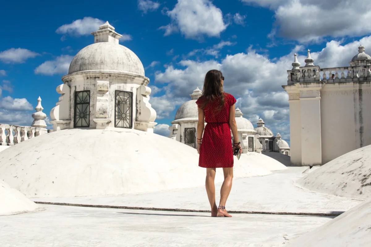 Tourist on whitewashed cathedral rooftop in Leon, Nicaragua