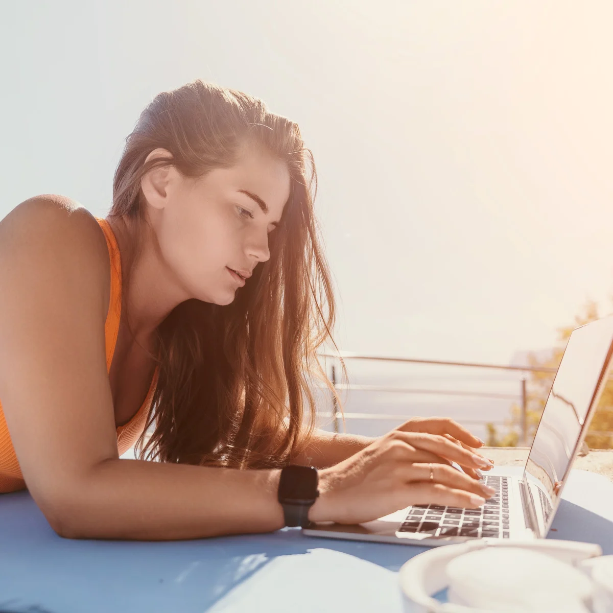 Digital nomad with laptop on beach