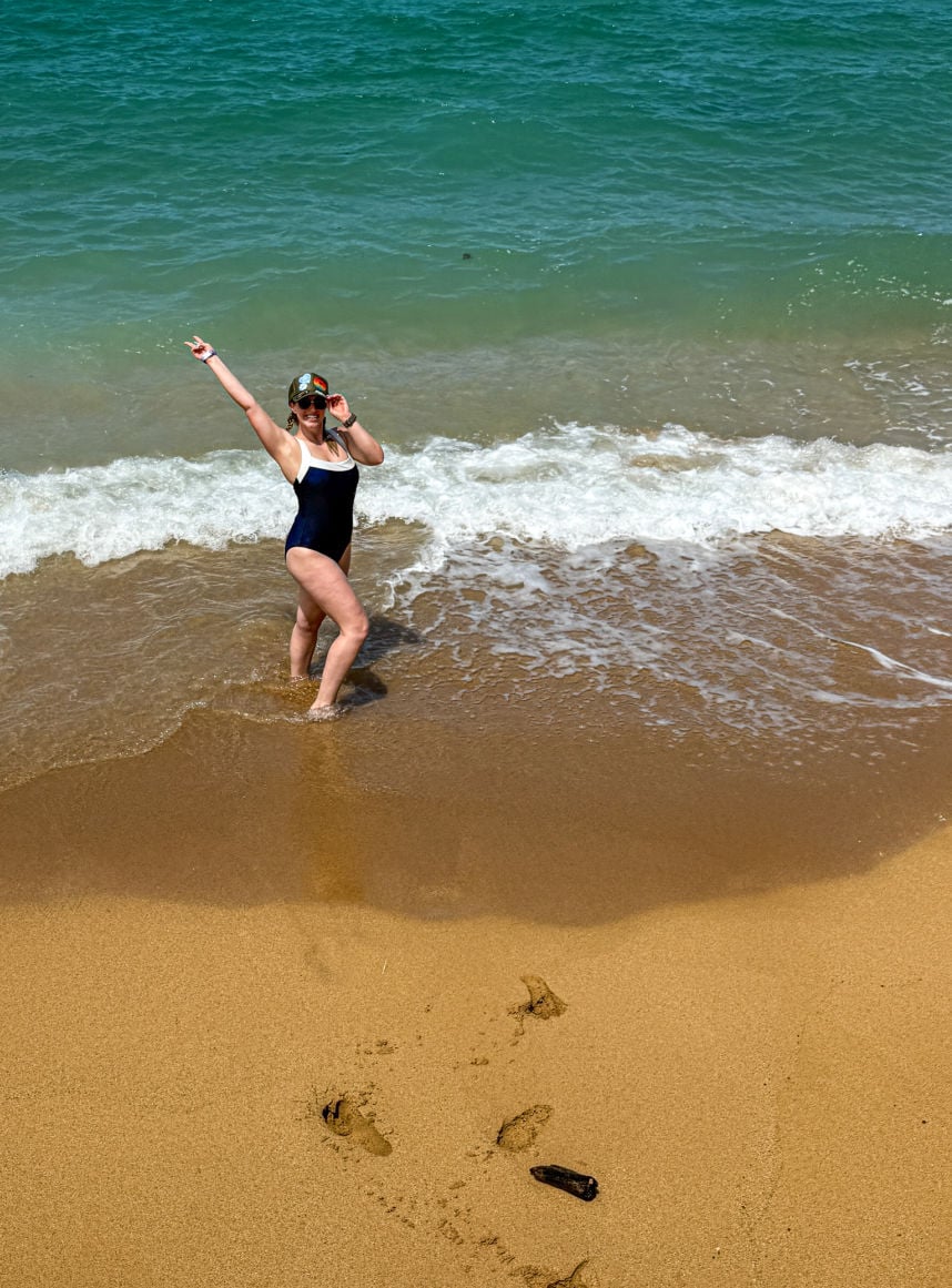 Liz Fox running into ocean after bike ride in Kauai
