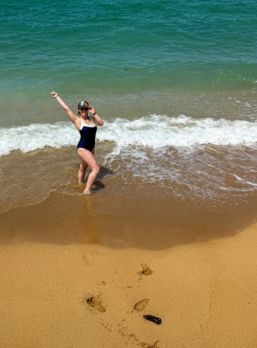 Liz Fox running into ocean after bike ride in Kauai
