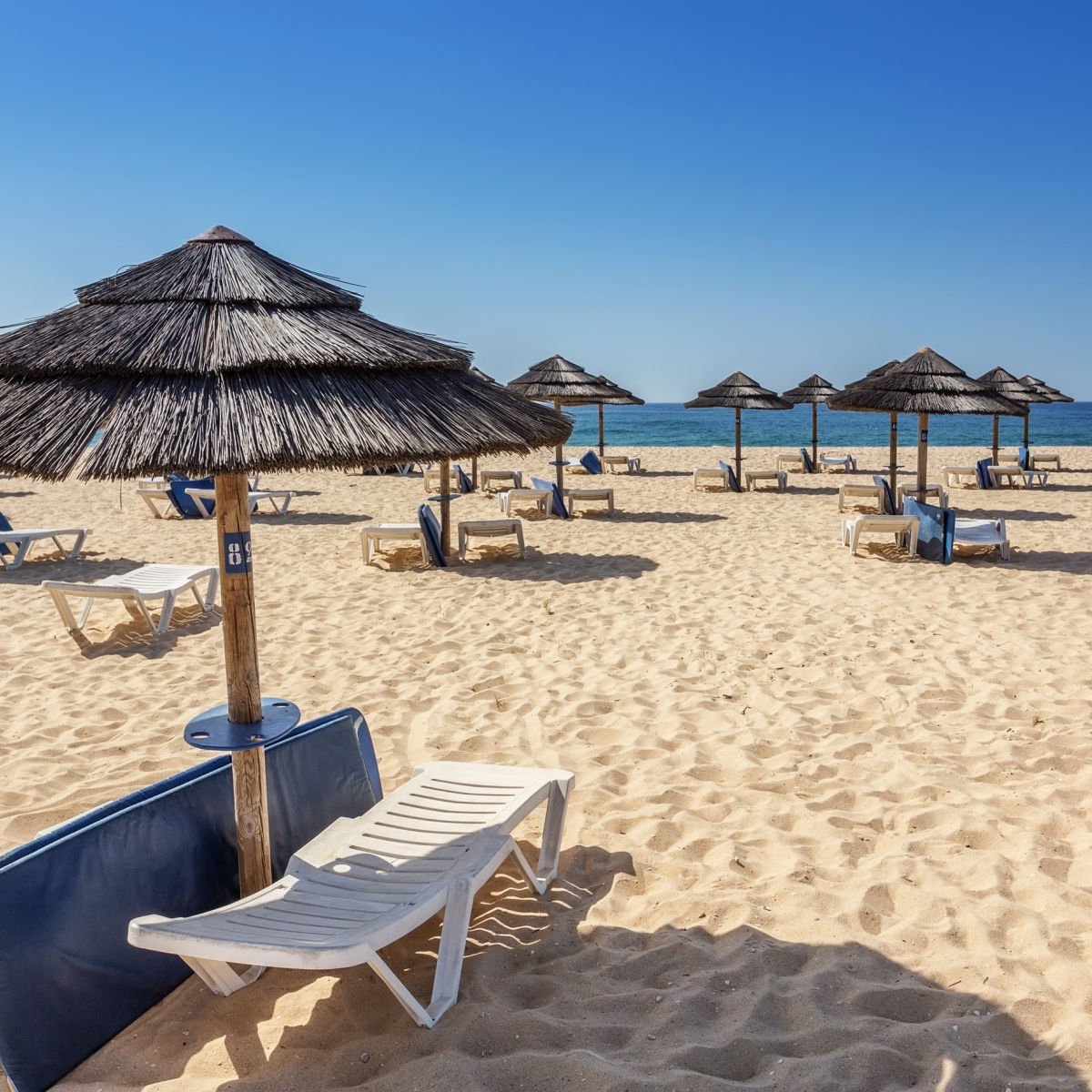 Parasols and loungers on beach in Tavira, Portugal