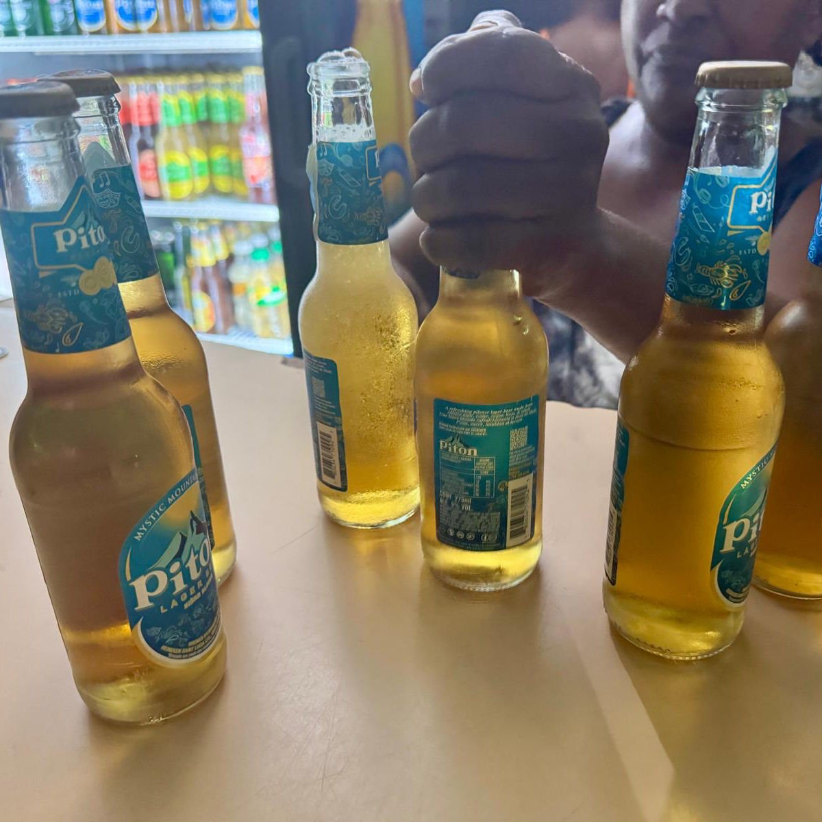 Round of Piton lagers at Castries block party in St. Lucia