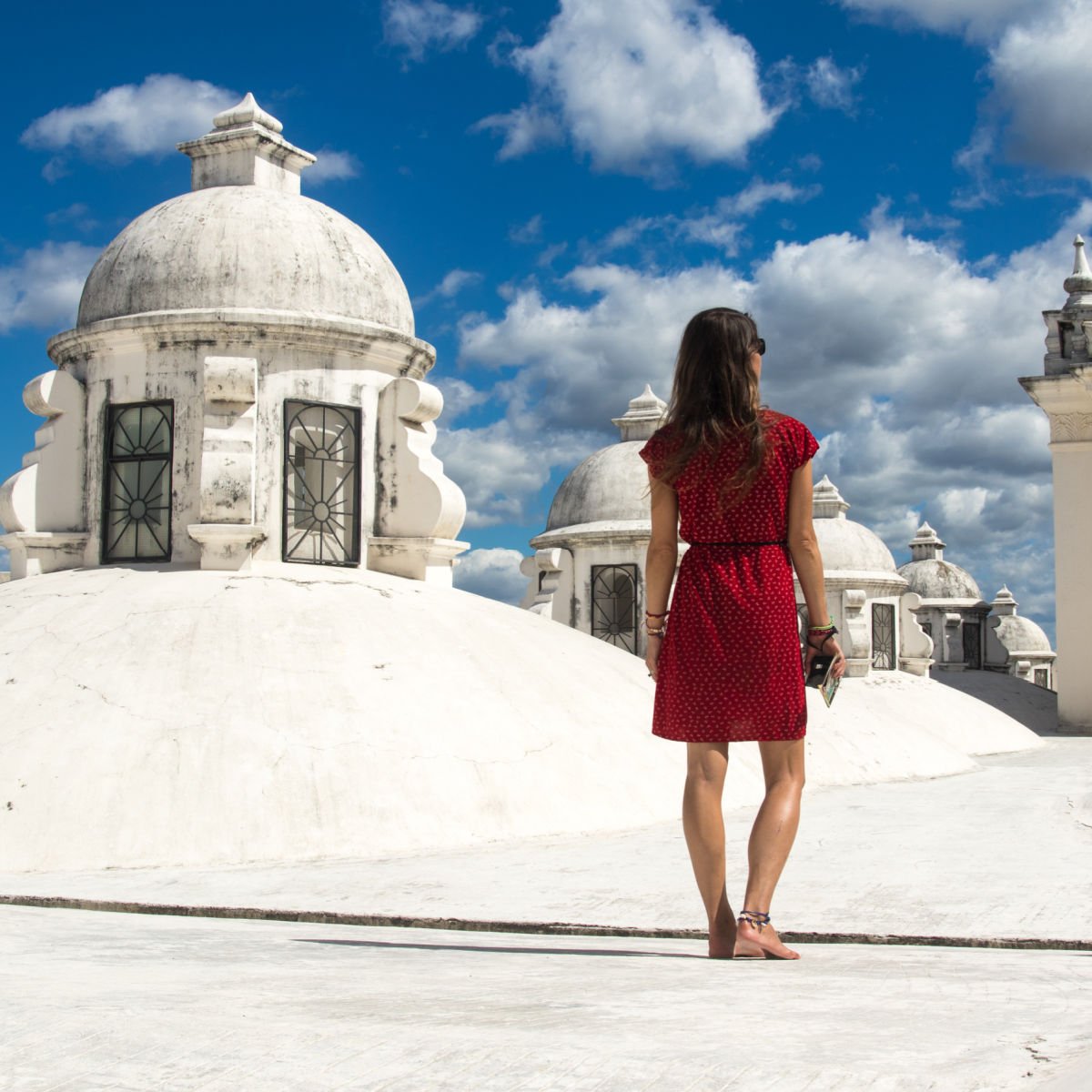 Tourist on whitewashed cathedral rooftop in Leon, Nicaragua