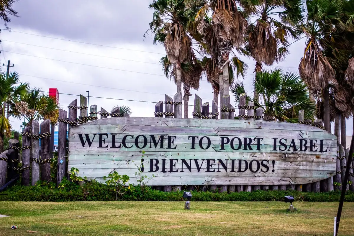 This Secret Beach Town Is The South's Most Underrated Winter Getaway Welcome to Port Isabel sign
