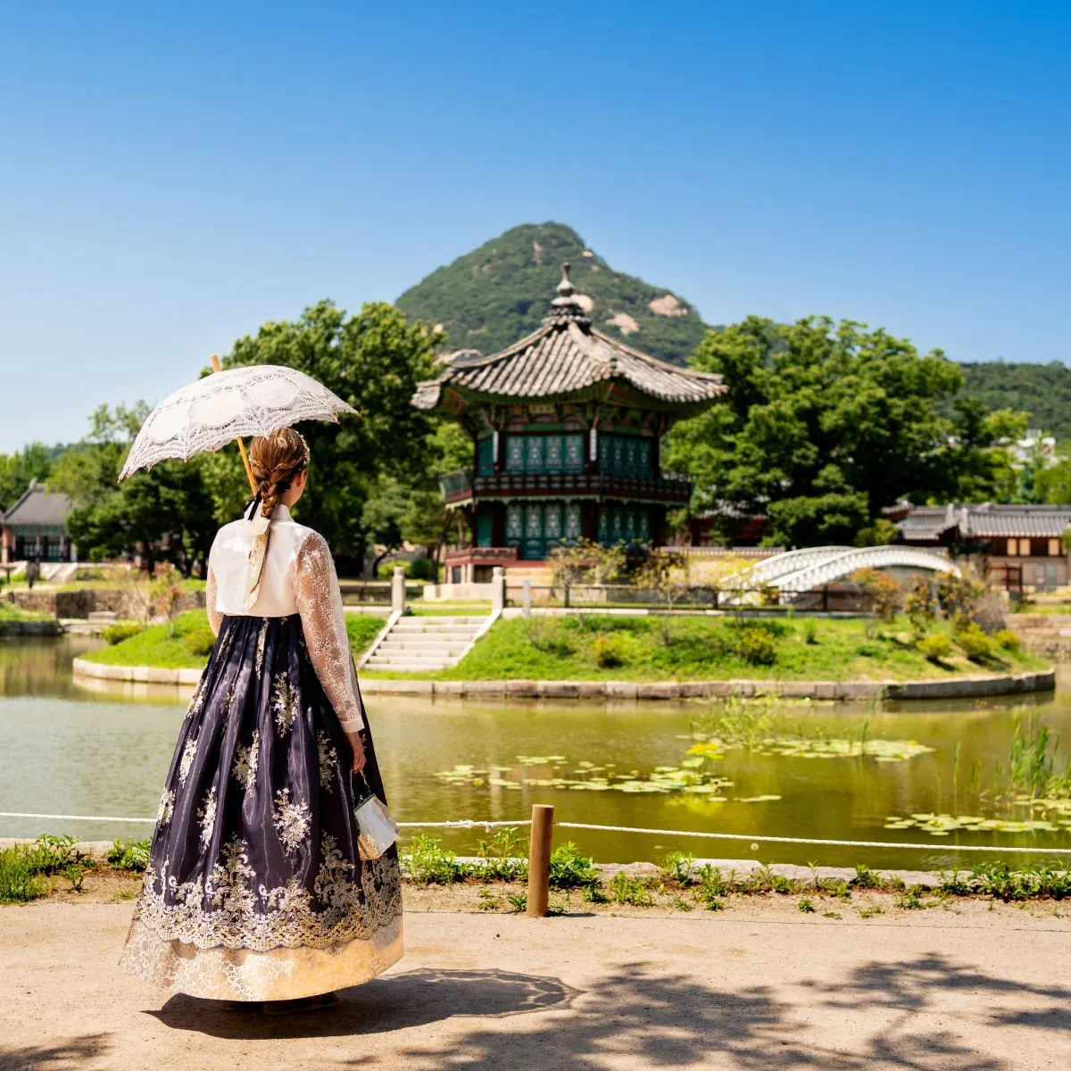 Woman visiting Gyeongbokgung Palace park garden in Seoul