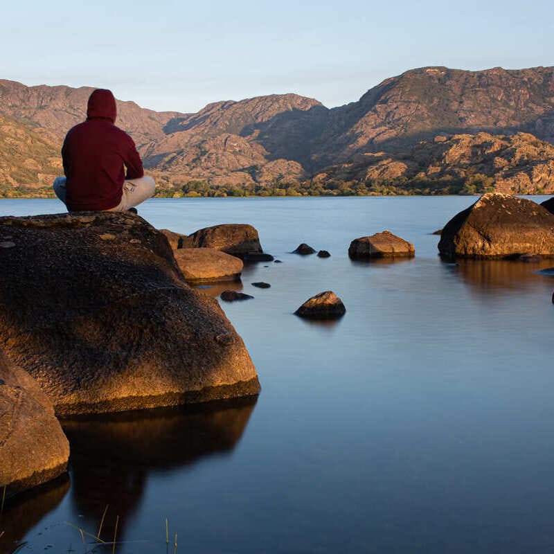 This Secret Medieval Town In Spain Wants More Americans To Visit! Young Man Admiring A View Of Sanabria Lake, Spain