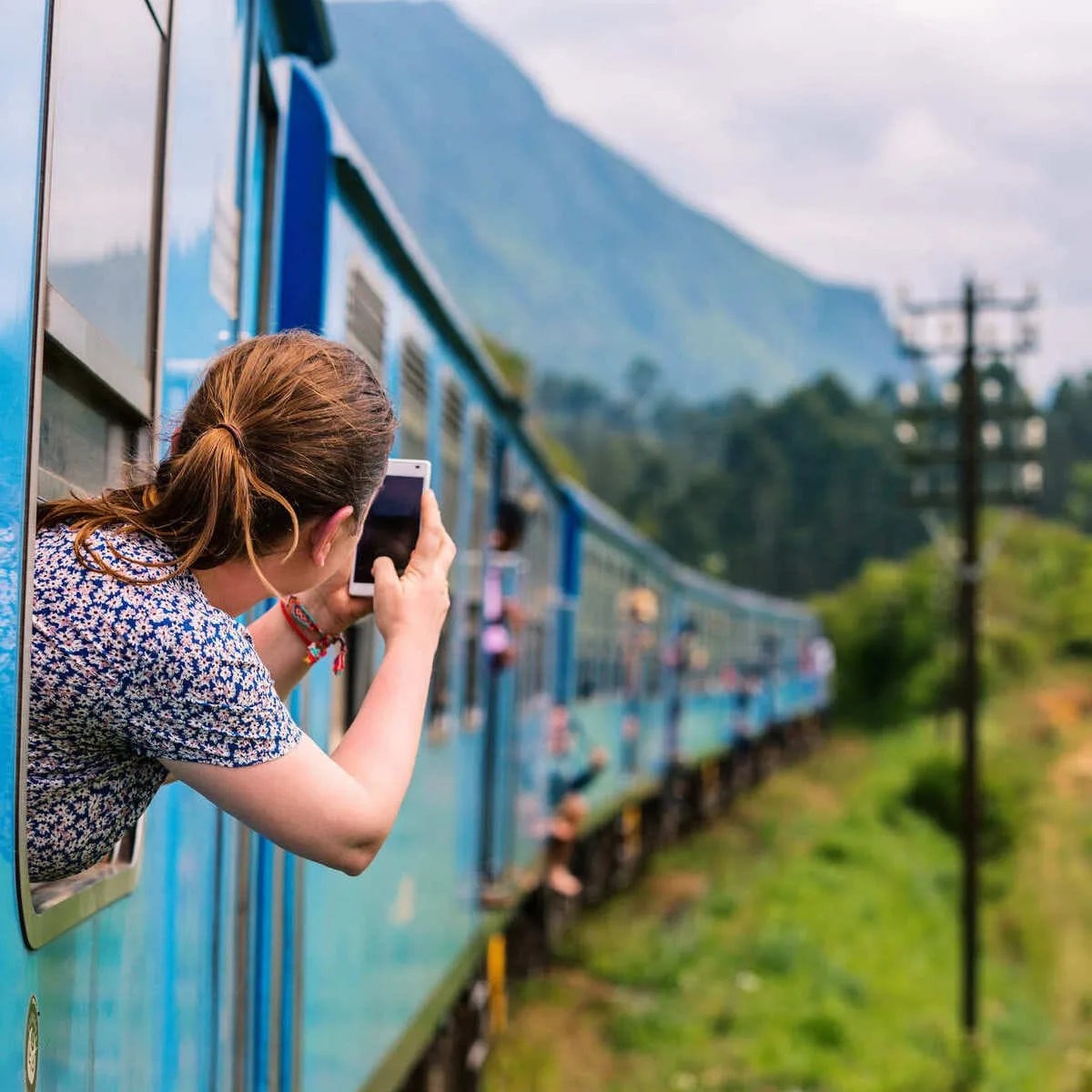 Young Tourist Taking A Picture Of The View On The Train To Ella In Sri Lanka, South Asia