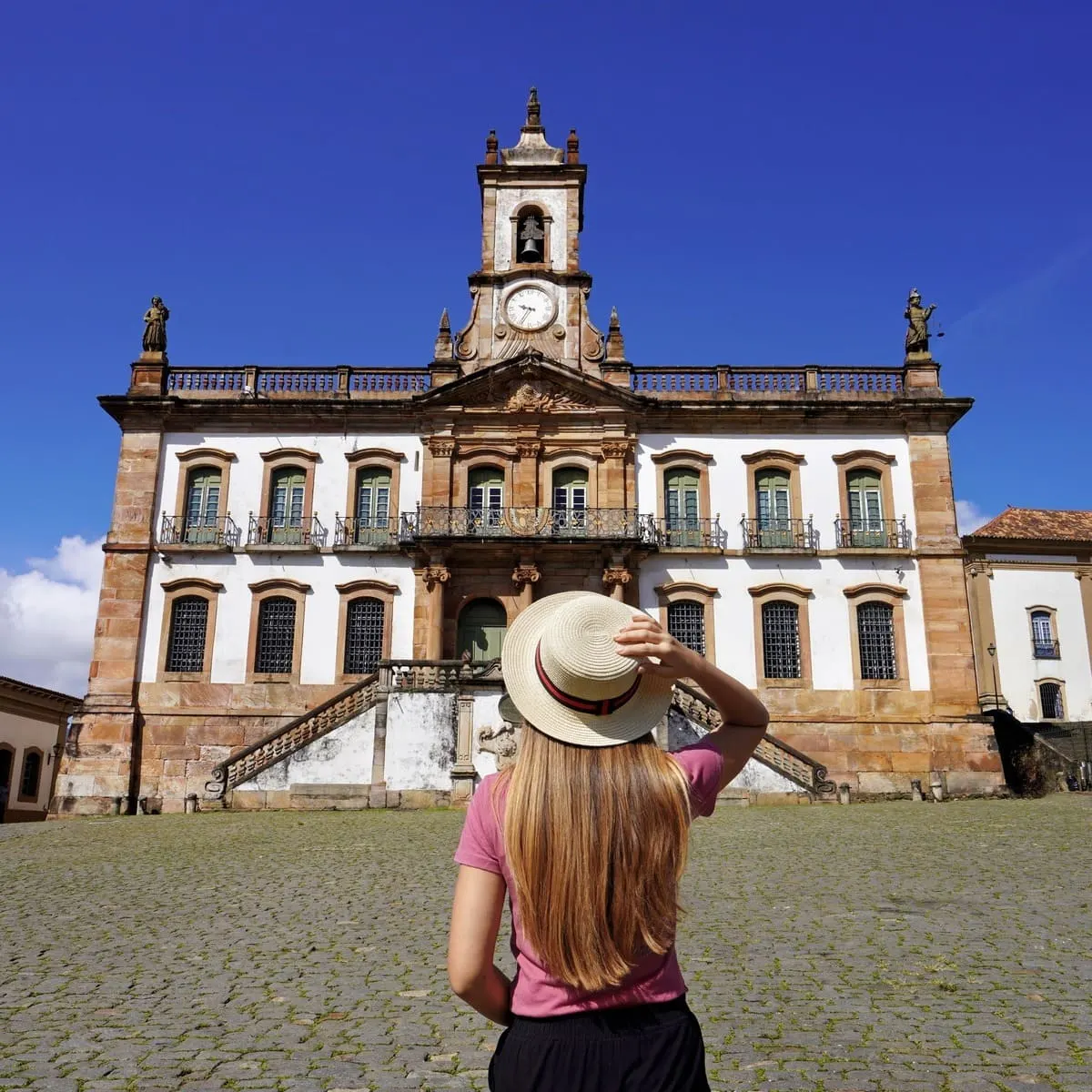 A Young Female Tourist Admiring A Colonial Building In Ouro Preto, Minas Gerais, Brazil