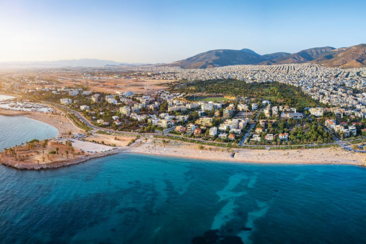 Aerial view of the coastline of Glyfada, south Athens, Greece, with beaches and marinas during summer sunset time